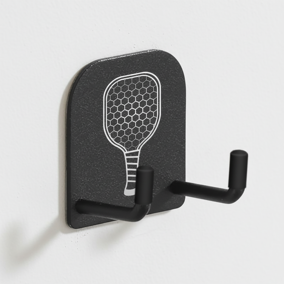 Black wall hook with paddle design on a white background