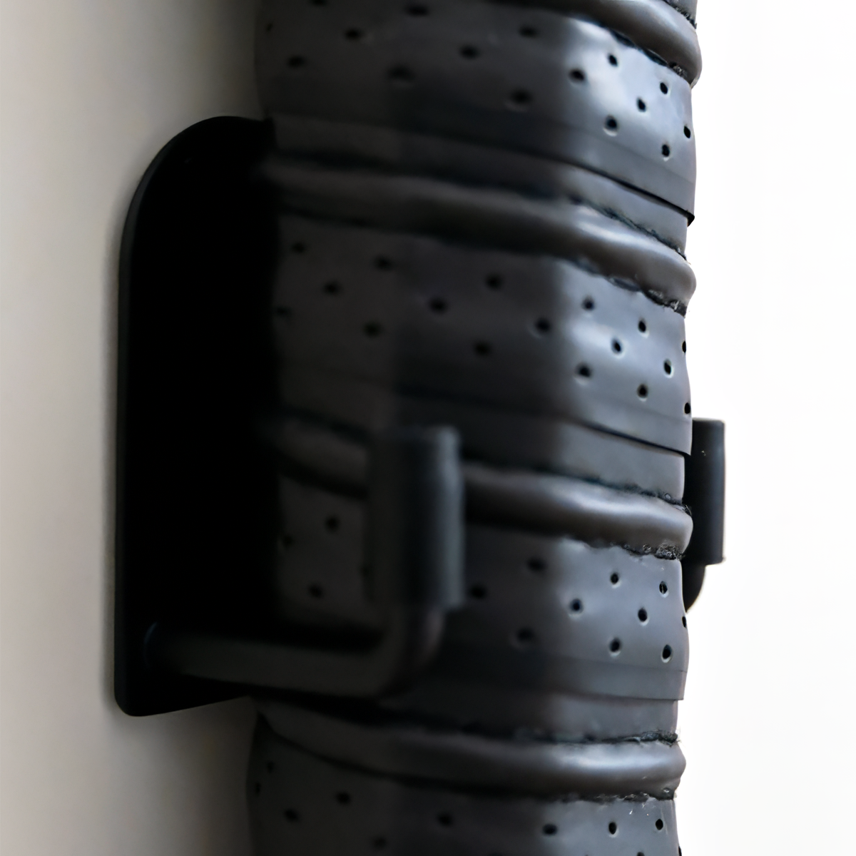 Gray leather belt with black buckle on a white background