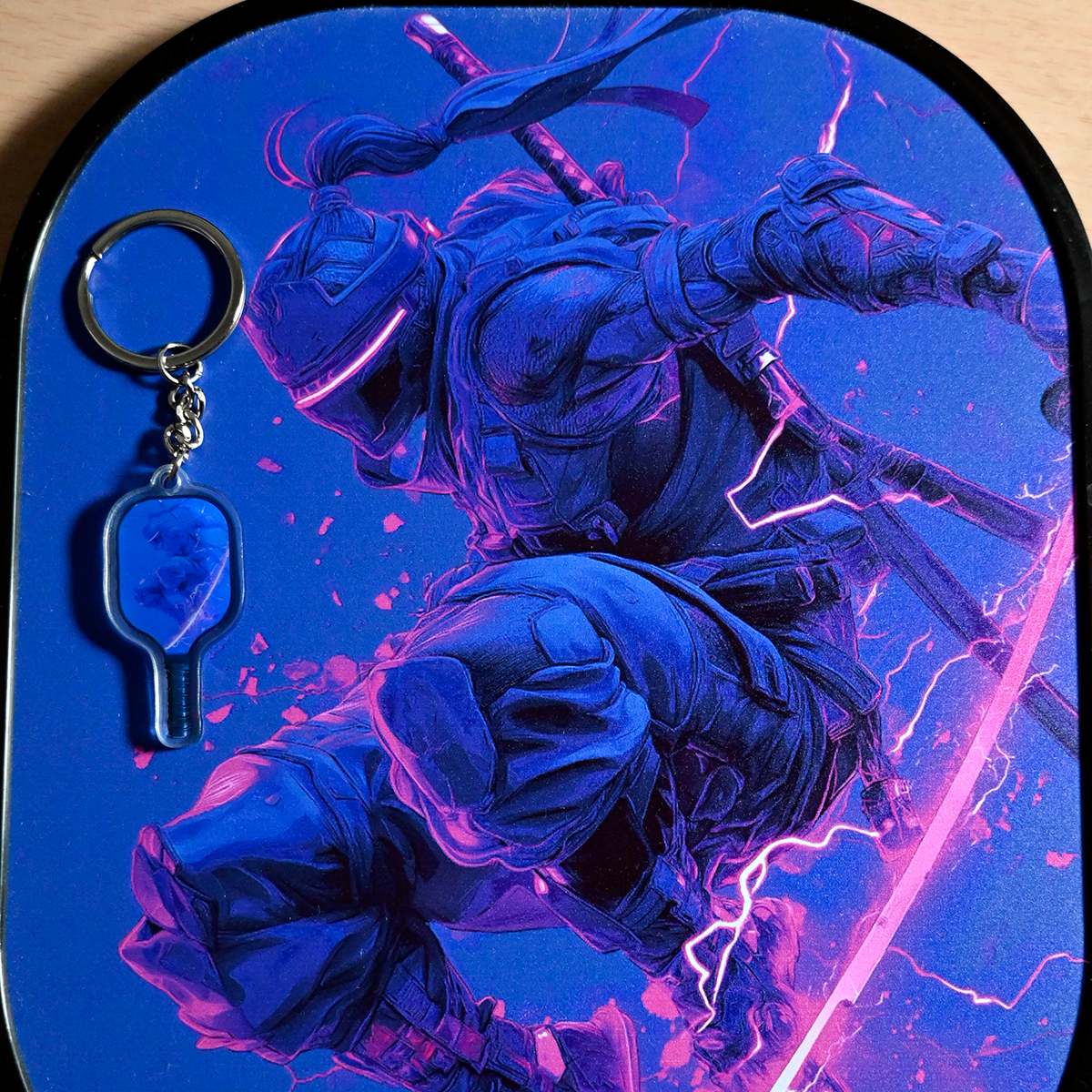 Keychain with a character design on a blue and purple gradient background