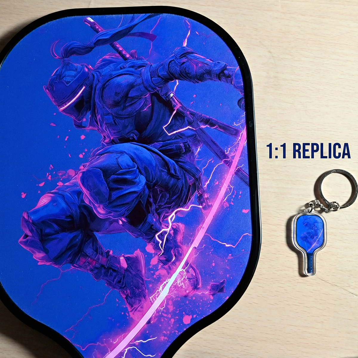 Mouse pad with a character design and a keychain on a wooden surface