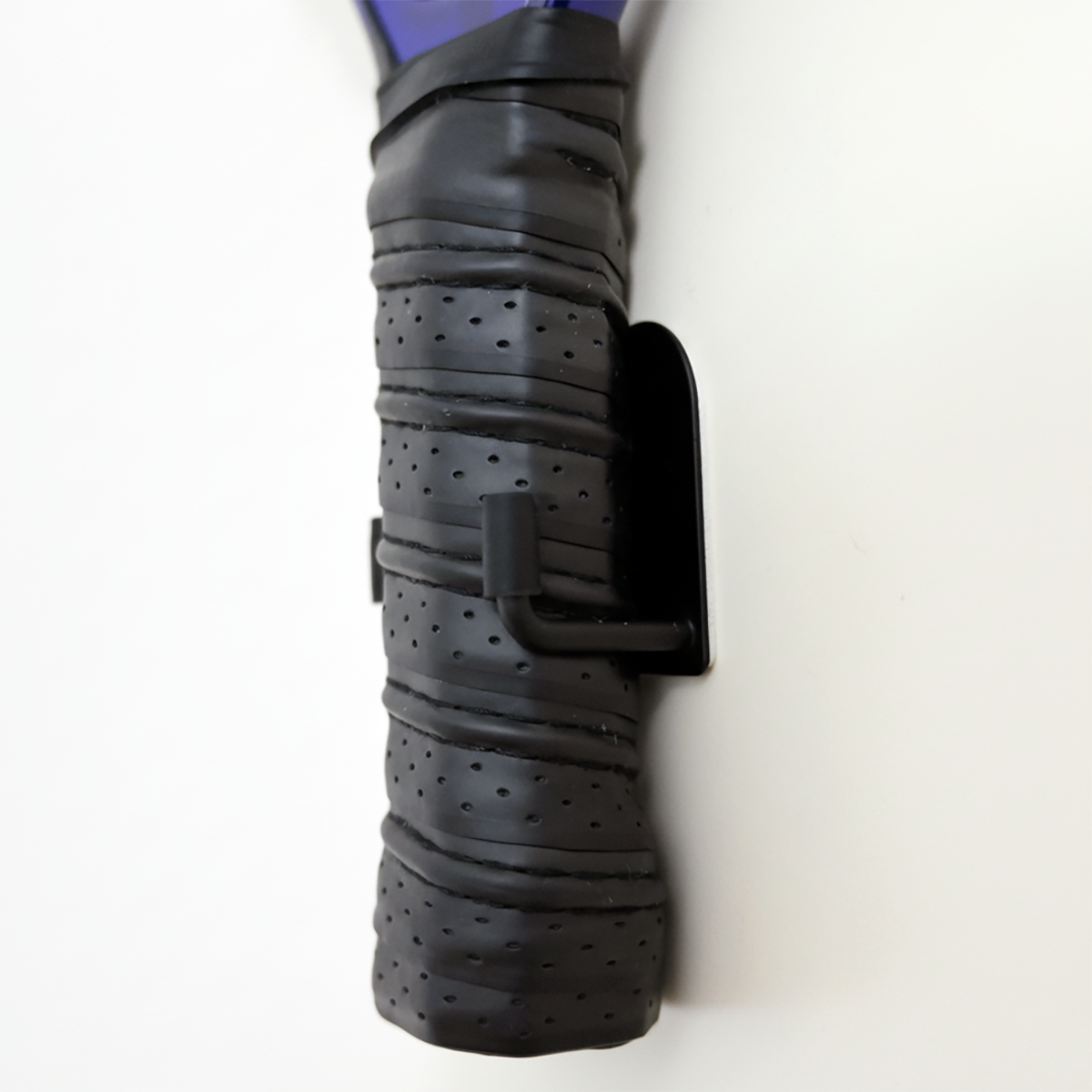 Black and purple garden tool handle on a white background